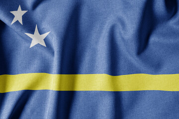 National Flag on Textured Fabric Background. Silk textured flag, realistic wave and flag look. CW  Flag of Curaçao