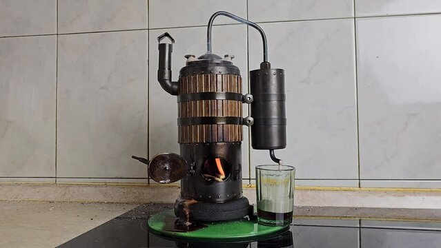 The process of distilling wine at a mini distillery using wood. Volume 400 ml.
