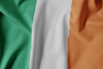 National Flag on Textured Fabric Background. Silk textured flag, realistic wave and flag look. IE  Flag of Ireland