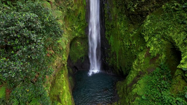 Beautiful aerial footage view of a bajos del toro waterfall in Costa Rica, with a gorgeous woman bathing 