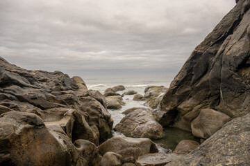 Fototapeta na wymiar Low Tide Laps The Smaller Rocks Along Kalaloch Beach