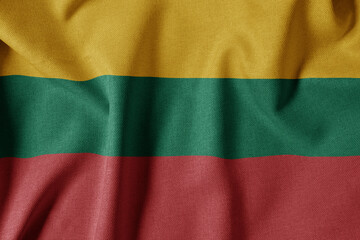 Obraz premium National Flag on Textured Fabric Background. Silk textured flag, realistic wave and flag look. LT Flag of Lithuania