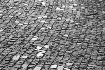 Background of stone floor texture. stone pavement in perspective. Old cobblestone road top aerial drone view. Old square cobble stone paving perspective background.