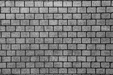 Naklejka premium top view of grey Stone street road pavement texture. Grey brick wall background close up. Gray stone tile block background with horizontal texture of gray brick. brick surface.