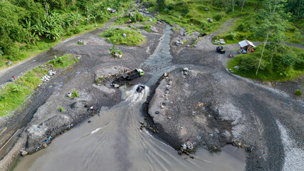 aerial view of tourists driving by jeep at the foot of Mount Merapi, located in the central part of Java Island in Sleman Regency, Yogyakarta
