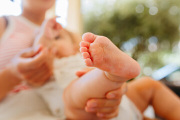 close up view of foot of new born baby held by mother