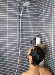 Contemporary Shower Experience: Urban Style Bathroom. man with brunette hair under the shower