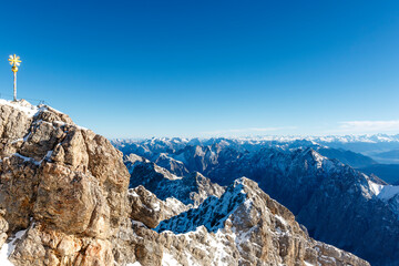 Golden cross on the German side of the Mount Zugspitze in Germany, Europe