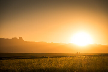 Sun setting over the distant hills in Drakensberg, South Africa