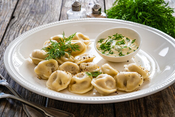 Pelmeni  - dumplings filled minced meat on wooden table
