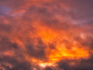 Fototapeta premium Colorful sunset sky with dark and light color tone and rich orange red color. Nature background. Dramatic cloudscape.