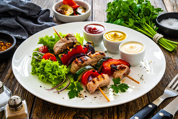 Meat skewers - grilled meat with vegetables on wooden background
- 744818751