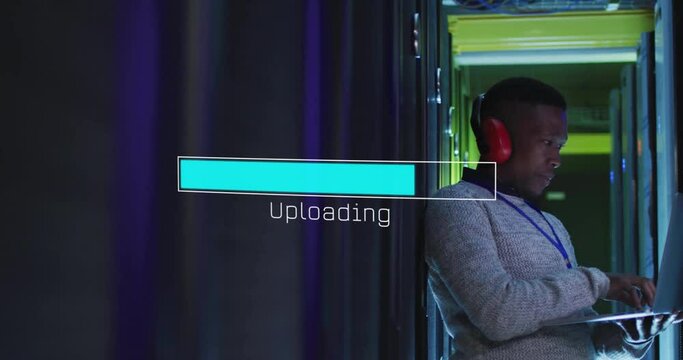 Animation of loading bar over african american man working in server room