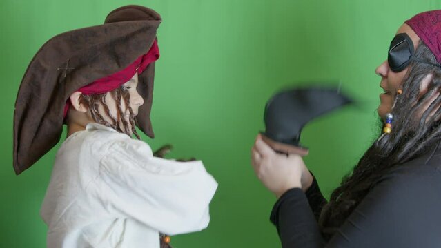 Pirates getting angry and fighting with cutlasses. Isolated on green background, slow motion. High quality 4k footage