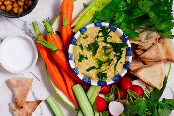 Hummus with fresh crispy vegetables. top view .