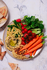 Hummus with fresh crispy vegetables. top view .