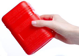 Red plastic box container in hand on white background isolation