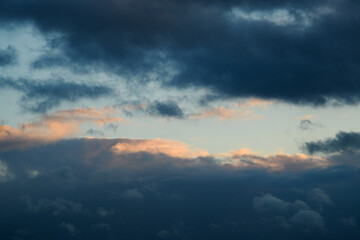Obraz premium Blue sky during the day. The weather is bad. Fluffy clouds. Light breaks through the clouds. Universal horizontal photo. The background picture.