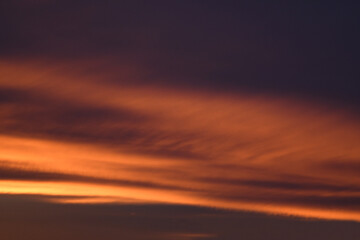 Bright clouds at sunset. Pink, blue romantic sky. Light breaks through the clouds. Universal photos. The background picture.