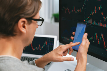 Smart stock investors pointing on screen with smartphone for market stock exchange along with...