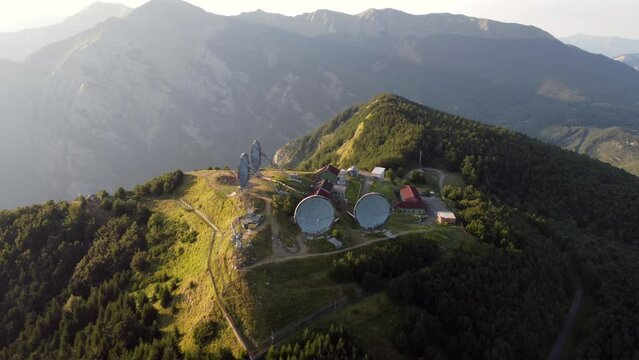 Aerial view of the big parabolic antenna of the radio station abandoned on the top of Monte Giogo, used during cold war. Comano, Massa and Carrara province, Lagastrello lake, Tuscany, Italy. 