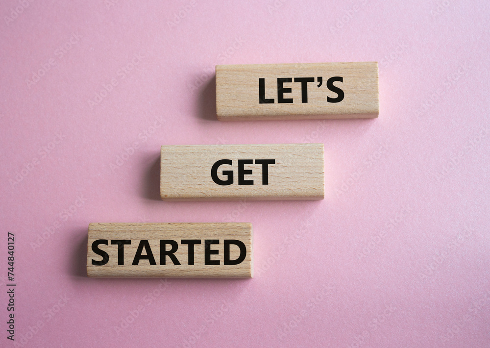 Canvas Prints lets get started symbol. concept words lets get started on wooden blocks. beautiful pink background.