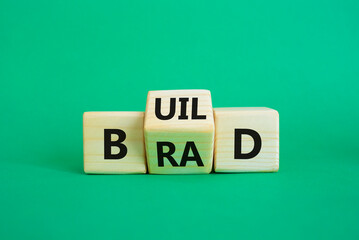 Build your brand symbol. Wooden cubes with words Build and Brand. Beautiful green background. Build your brand and business concept. Copy space