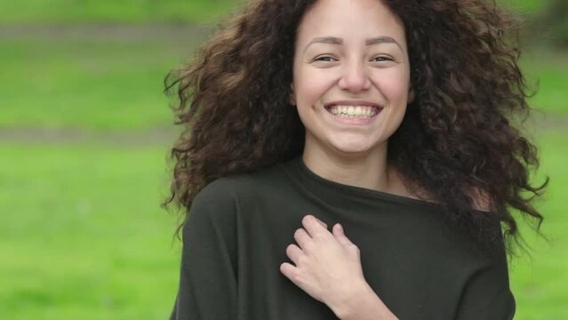 happy  young woman laughing and moves her face and her beautiful curly hair
