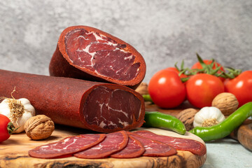 Turkish pastrami. Traditional Turkish cuisine flavors. Bacon slices on cutting board. Local name sivas pastirma. Close up