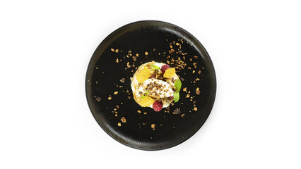 Sweet dessert with fruits on a black plate