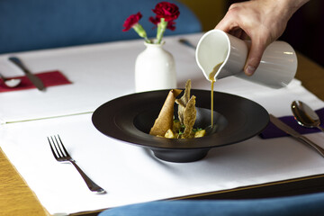 Traditional polish soup. Zurek in restaurant. Żurek with egg. Soup on table on table.