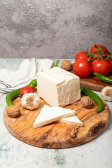Full fat cow cheese. Fresh cow cheese on cutting board
