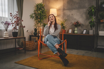 Obraz premium one young woman at home use mobile phone smartphone have a call talk