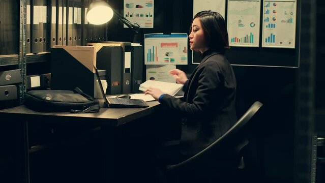 Asian police agent opening criminal investigation at private company, managing law enforcement and criminology. Detective evaluating forensic evidence and archived folders from old cases. Camera A.