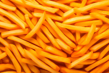 Close-up of crispy golden fries, indicative of a tasty, indulgent fast food snack with a focus on texture and color.






