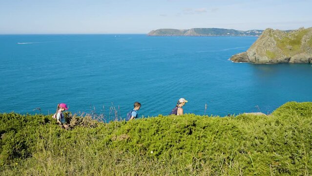 Beautiful Ocean View With Family Walking Along Coastal Foot Path