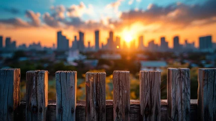 Cercles muraux Skyline Sunset view over an urban skyline from behind a wooden fence