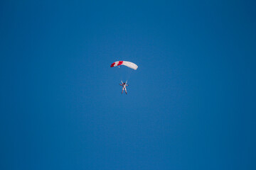 A skydiver with a parachute in the air