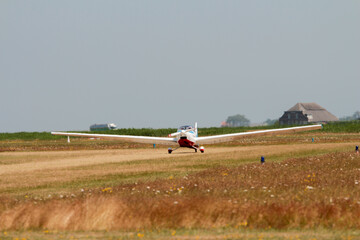 The motor glider on the runway during takeoff at Texel Airport