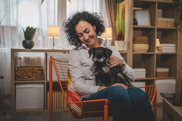 portrait of adult caucasian woman mature female with pet dog at home