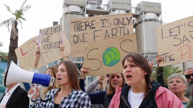 Group of different people holding posters protesting against climate change. Global warming and environment concept.