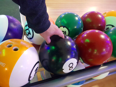 a person playing bowling, catching a ball