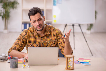 Young male designer working in the office