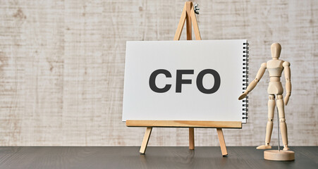 There is notebook with the word CFO. It is an abbreviation for Chief Financial Officer as...
