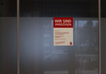 glass door with red rectangular sign prominently displayed written in German and indicates that the...