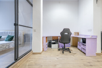 An open office of a loft-type apartment with industrial-type decoration with a metal bubble structure with transparent panels separating the room