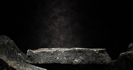 natural black stones for the podium on a dark background