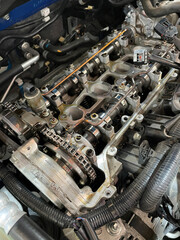 Explore the car engine with the rocker cover removed, revealing detailed components for maintenance...