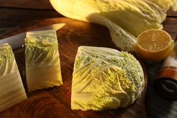 Fresh Chinese cabbage and lemon on table, closeup