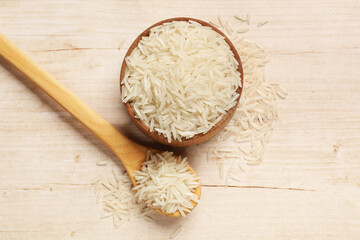 Uncooked raw basmati rice on white wooden table, flat lay